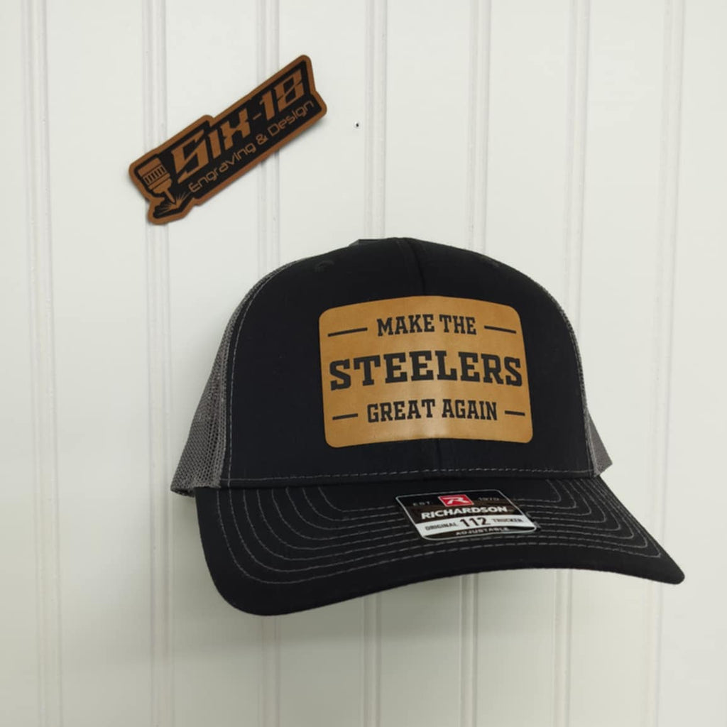 Black trucker hat with 'Make the Steelers Great Again' patch on a white background
