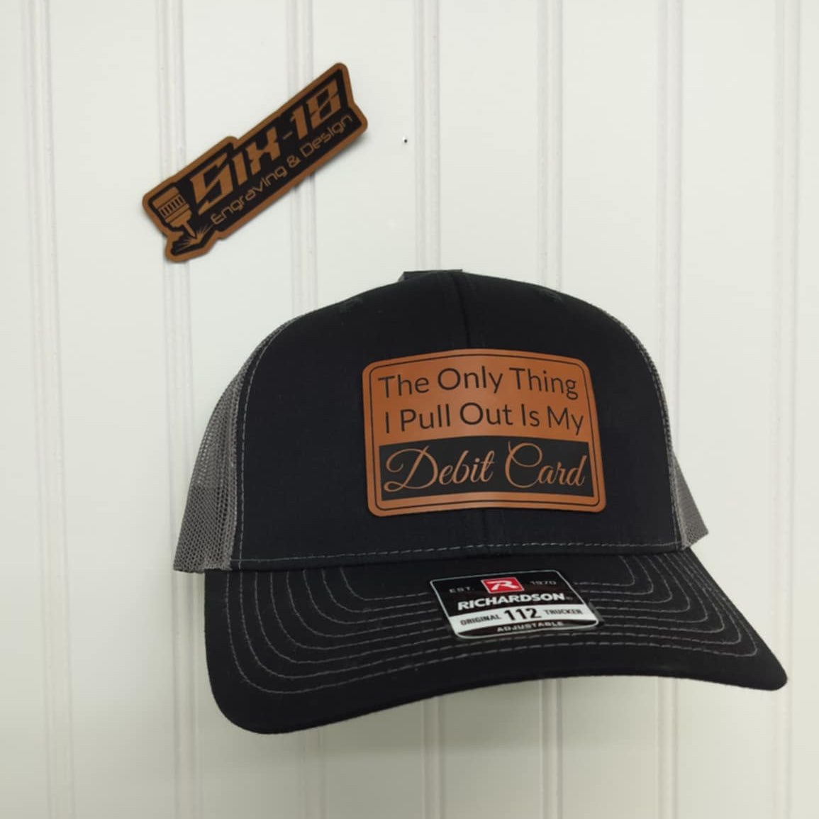Black cap with brown patch and Funny saying